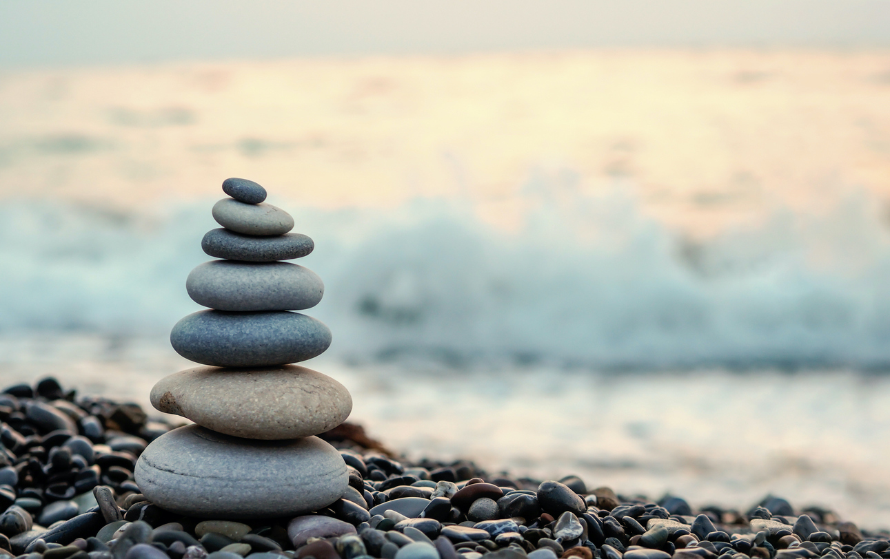 made of stone tower on the beach and blur background